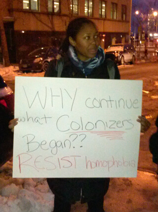 A protester outside of Uganda House on East 45th Street the evening of February 10. | GAY CITY NEWS