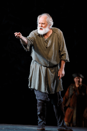 John Lithgow (foreground) in The Public Theater’s free Shakespeare in the Park production of King Lear, directed by Daniel Sullivan with scenic design by John Lee Beatty, running at the Delacorte Theater in Central Park July 22 through August 17. Photo by Joan Marcus