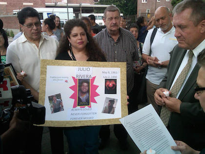 Councilmember Daniel Dromm looks on as Julio’s brother Ted Rivera (l.) and Ted’s daughter Jenny hold a poster commemorating Julio. | GAY CITY NEWS