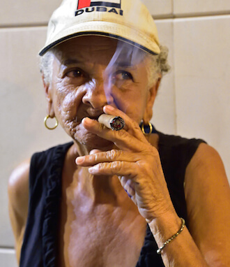 A woman tries to keep cool as she has a smoke. | DONNA ACETO