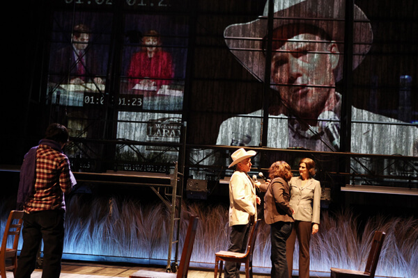 Michael Winther (in hat) and Mercedes Herrero (with mic) in the Tectonic Theater Project's production of "The Laramie Project Cycle" at BAM, through February 24. | JULIETA CERVANTES