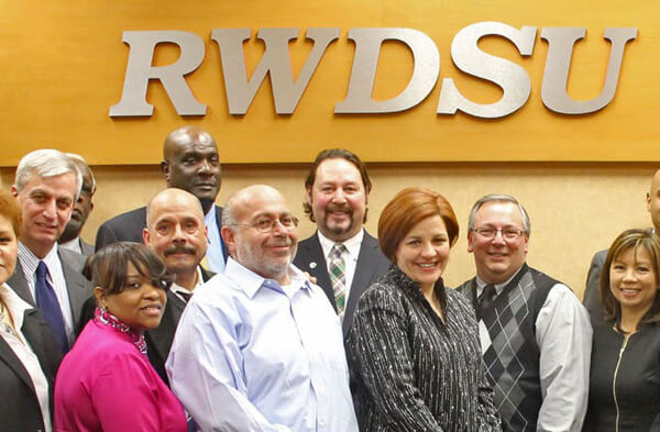 City Council Speaker Christine Quinn with leaders of the Retail, Wholesale and Department Store Union, including (to her immediate left, front row) its president Stuart Appelbaum. | RWDSU