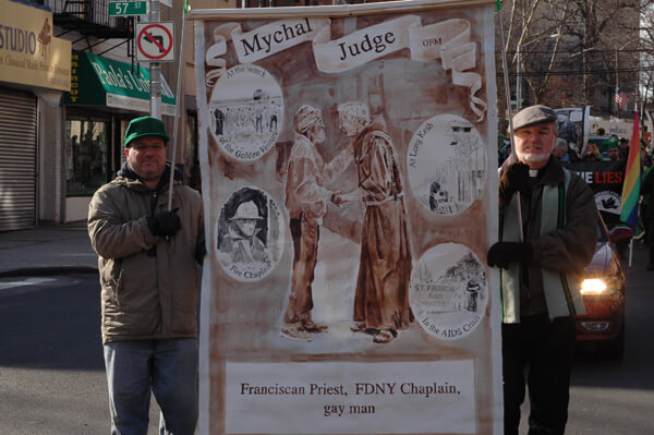 Marchers carry a banner in memory of Father Mychal Judge, the gay Fire Department chaplain killed on 9/11. | GRCC