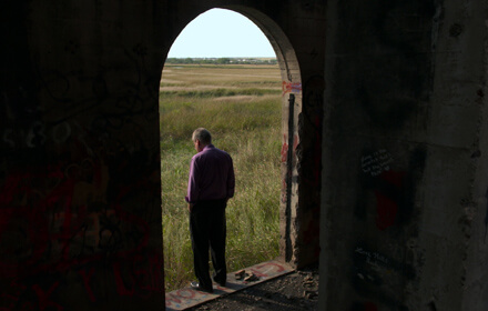 Pastor Jay Reinke stands inside the doorway of an abandoned church. | DRAFTHOUSE FILMS