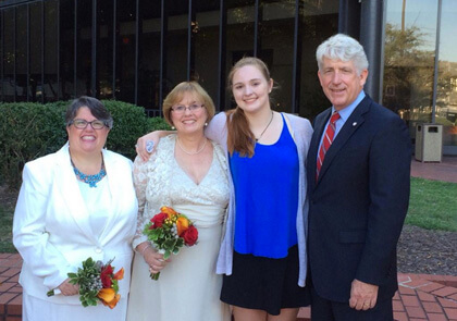 Virginia Democratic Attorney General Mark Herring after officiating at the wedding of Carol Schall and Mary Townley, the marriage equality plaintiffs in that state, who are seen here with their daughter Emily. | TWITTER/ AGMARKHERRING