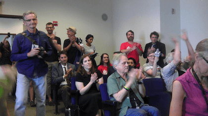 Hearing attendees applaud the landmarking decision. | RICK LANDMAN