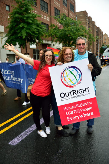 Grand marshal Jessica Stern, executive director of OutRight Action International, with her stepmom Heather and dad Allan Stern.