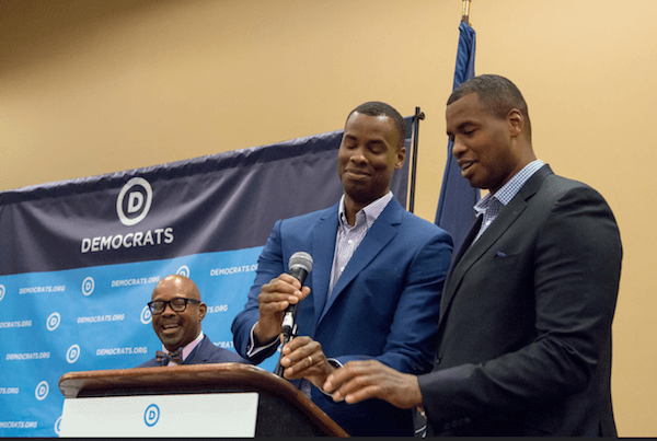Jaron Collins (podium left) and the first openly gay NBA player Jason Collins (podium right), twin brothers who have both retired from the NBA. | DNC 