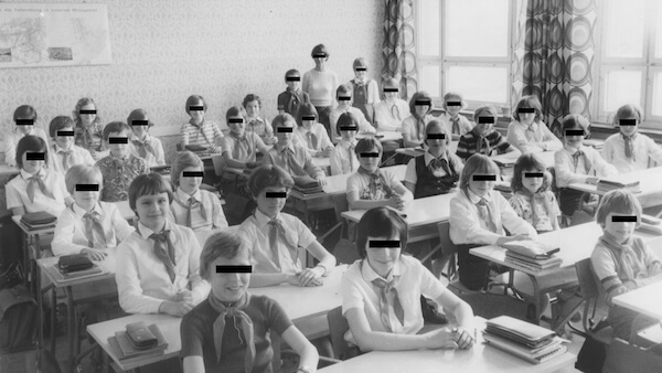 A still from a Stasi film of Petra Epperlein’s childhood classroom, with her eyes the only ones not blacked out in this image. | BOND/ 360 