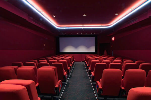 The Quad Cinema’s “red” theater, with the U in Quad emblazoning the ceiling in neon. |  CALEB CALDWELL 